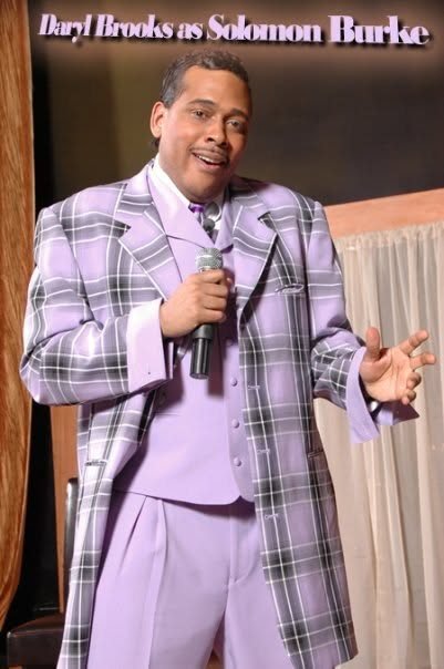 Daryl Brooks performing as Solomon Burke in a lavender plaid suit