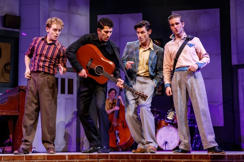 The Million Dollar Quartet on stage with guitars